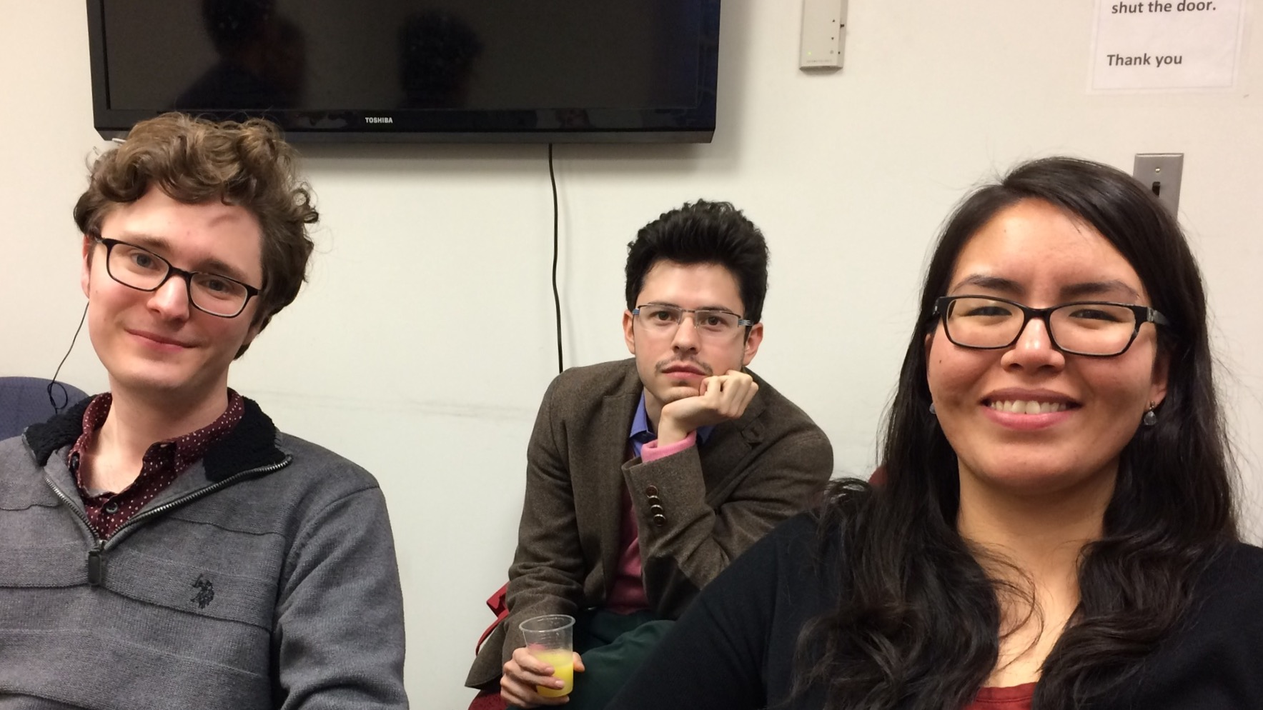 A selfie of three classmates sitting together in the classroom